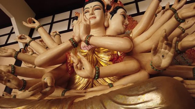 Many-armed many faces god giant Shiva symbol religious buddhism deity statue sculpture close hands details inside the temple. Authentic mythological Asia. Gimbal orbit