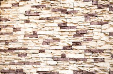 The background of the wall, lined with artificial stone irregularly shaped white and lilac. Backgrounds graphic design  textures.