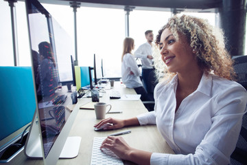 Young business woman with computer in the office.