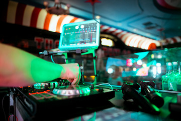 Fototapeta na wymiar DJ mixing music on console at the night club