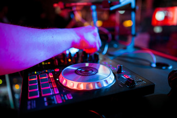 Obraz premium DJ mixing music on console at the night club