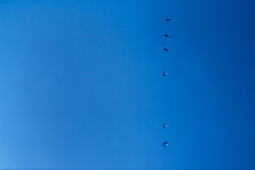 Water bubbles in the blue sky. Water drops on blue background. Aqua, rain, weather, clear. Life, freedom, ease.