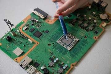 Cleaning and replacing thermal paste on a CPU from a limited addition computer console motherboard