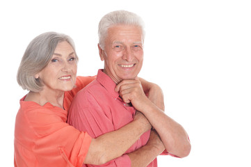 Smiling senior couple wearing bright clothing on white background