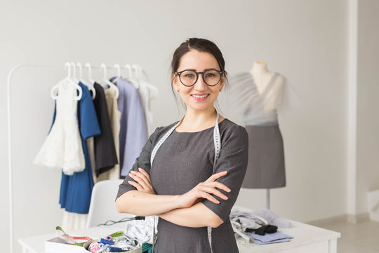 Dressmaker, fashion designer, tailor and people concept - Beautiful fashion woman designer standing in studio