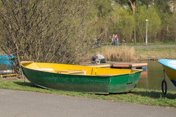 Old boat on the shore near the lake.