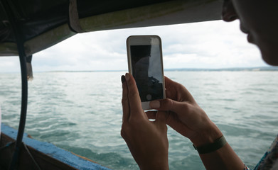 Young female traveler sailing in a local Asian boat