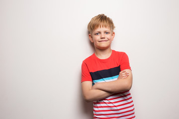 Little smiling boy in t-shirt isolated on white background. Studio portrait