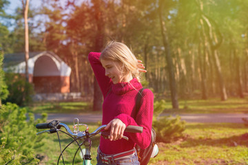 Fototapeta na wymiar Teenager girl on a bicycle in the park.
