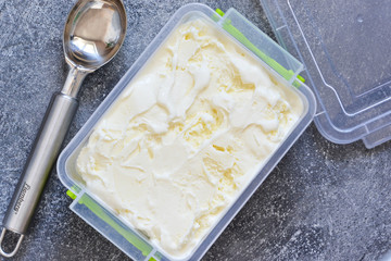 Vanilla, creamy ice cream on a concrete background. View from above.
