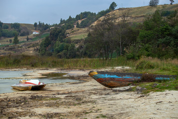 Multiple exposure of abandoned old boats on the white beach of lake Tota, the largest natural lake of Colombia, located at the central Andean mountains of Colombia.