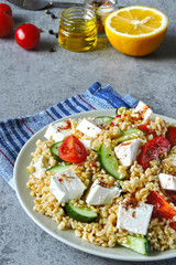 Healthy salad with bulgur, vegetables and feta. Middle Eastern style.