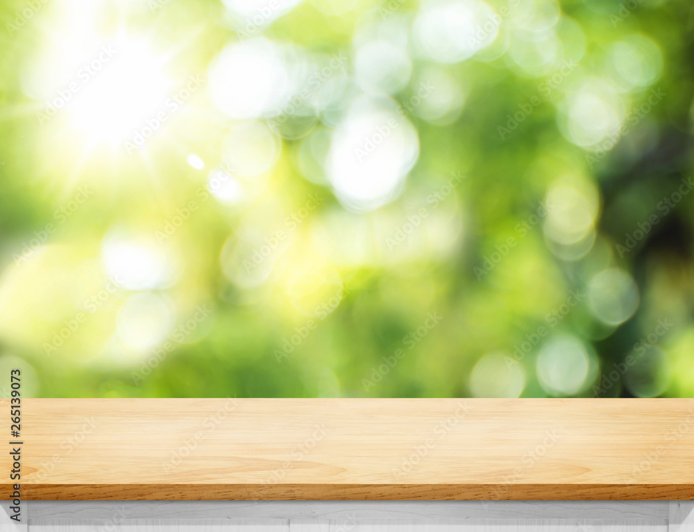 Aufkleber Empty wood plank table top with blur tree in park with bokeh light at background,Mock up template for display of your design,Banner for advertise of product
