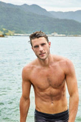 Handsome guy emerging from sea, portrait