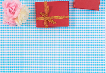 gift box with red isolated on Plaid background. Holiday decoration for Mother's Day or Women's Day.