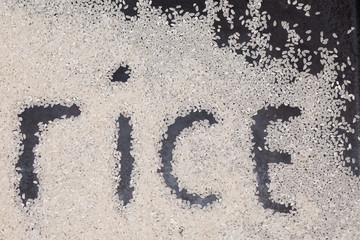 rice scattered on a black background with the inscription