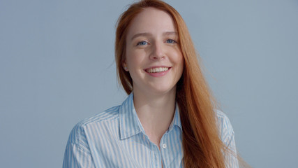 Ginger head red hair, ginger hair model with blue big eyes in studiohappy smiling to the camera....
