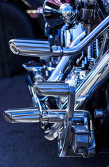 close up of chrome motorcycle foot pedals