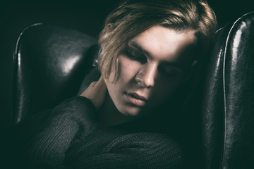 Young attractive guy is resting on the couch.