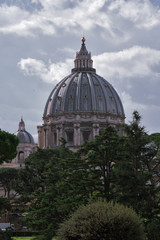 VATICAN - march, 2019: Vatican gardens view with St. Peter's Basilica dome behind the trees, Vatican, Rome