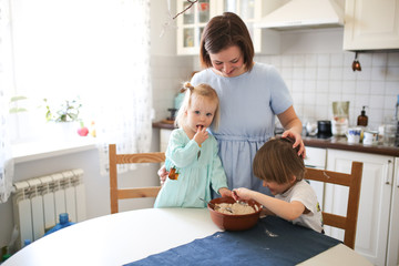 Little sibling with mother make linen flour dough