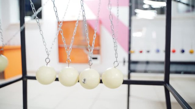 Newton's cradle showing laws of physics in motion. Museum of Science and newton pendulum
