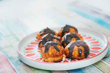 Profiterole with vanilla and chocolate sauce