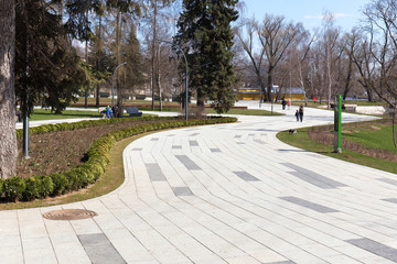 Winding footpaths in the city Park of Moscow. Citizens walking in the Park. Spring , cloudy. Urban landscape. The VDNKH exhibition center, Moscow, Russia 19 April 2019.