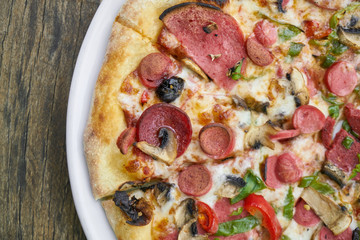Delicious pizza served on porcelain plate