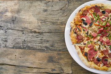 Delicious pizza served on porcelain plate