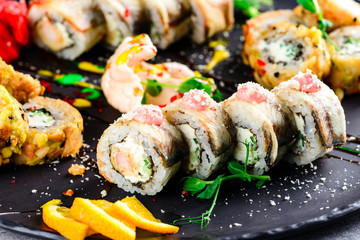 Sushi roll on a plate topped with pea sprouts