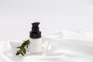 Beauty cream in dispencer bottle on white background. Face cream, spa treatment. Skincare. Copy...