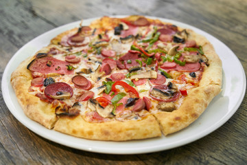 Delicious pizza served on porcelain plate
