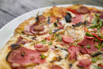 Delicious pizza served on porcelain plate