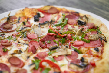 Delicious pizza served on porcelain plate