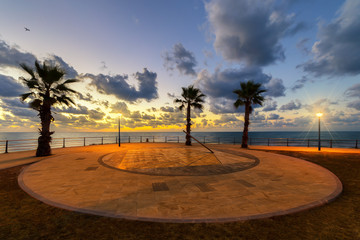 A sundial in the morning at sunrise at the beach of Playa Flamenca in Orihuela Costa Spain