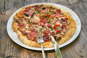 Delicious pizza served on porcelain plate