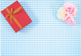 gift box with red isolated on Plaid background. Holiday decoration for Mother's Day or Women's Day.