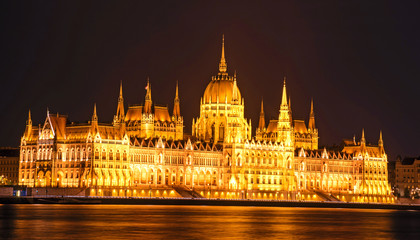 Fototapeta na wymiar The picturesque view of of the Parliament in Budapest, Hungary, Europe in evening on lamps light