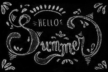 Summer theme. Chalk handwritten decorative lettering Hello summer on blackboard