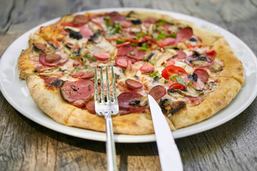 Delicious pizza served on porcelain plate