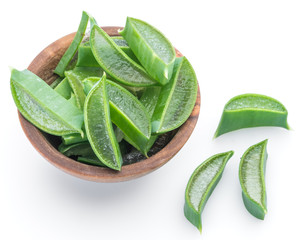 Fresh aloe vera slices in the wooden bowl on white background.
