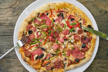 Delicious pizza served on porcelain plate