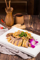 Pressed salted duck meat slices in a white ceramic dish