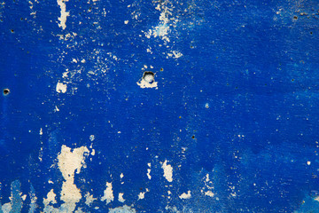 Abstract grunge blue, navy background texture. Peleed old paint, cracked blue wall