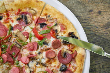 Delicious pizza served on porcelain plate