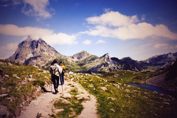 Fototapeta na wymiar two hiker in front of the Midi d'Ossau and in the Ayous Lakes, Pyrenees, France