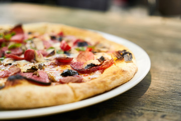 Delicious pizza served on porcelain plate