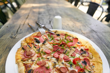 Delicious pizza served on porcelain plate