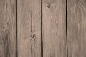 Wooden surface, texture. Pine planks. Sepia tone. A fence from the tightly nailed wooden planks. Close-up. Selective focus. Copy space.